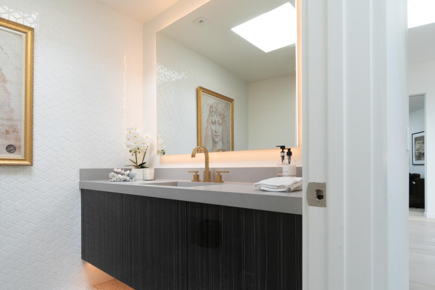 1505 Venadero Road Pebble Beach, CA 93953 - Photo 21 of 36 a bathroom with a double vanity sink and a mirror