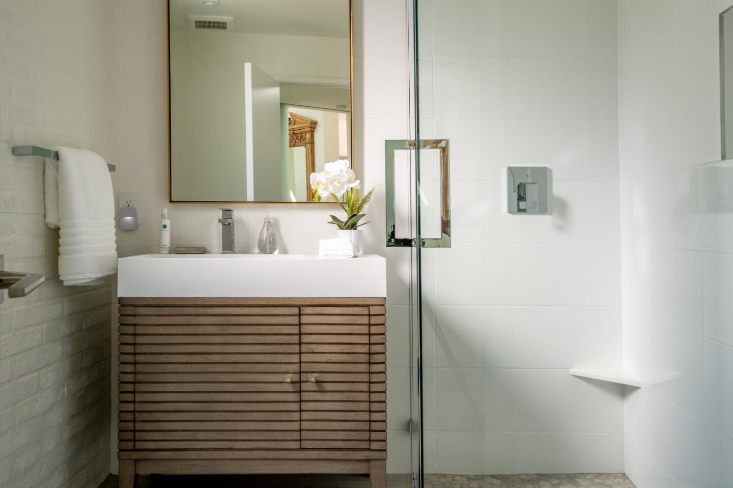 1505 Venadero Road Pebble Beach, CA 93953 - Photo 23 of 36 a bathroom with a sink and a mirror