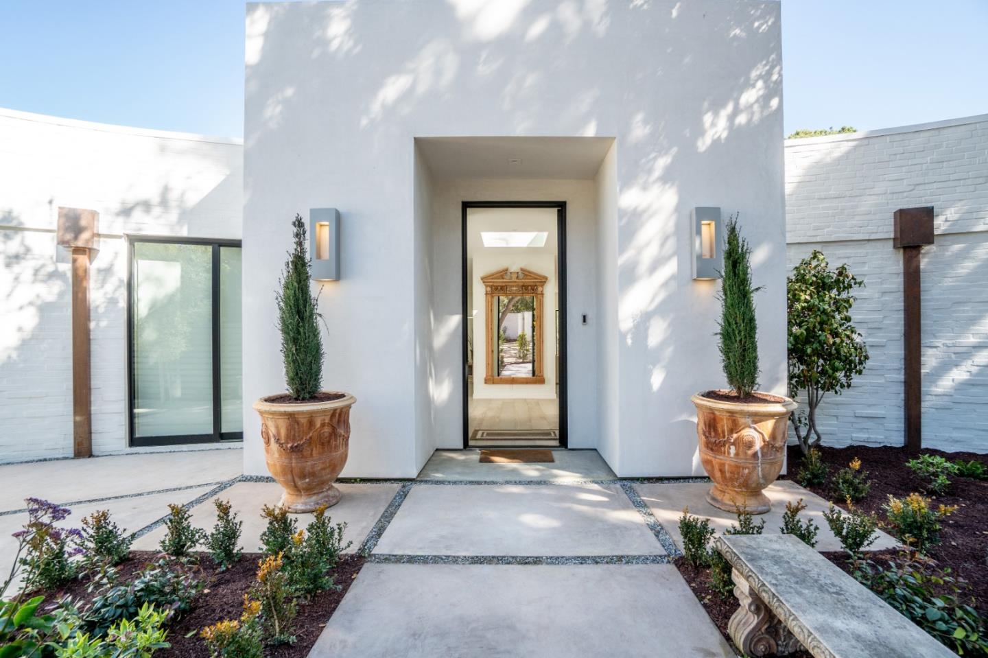 1505 Venadero Road Pebble Beach, CA 93953 - Photo 3 of 36 a front view of a house with potted plants