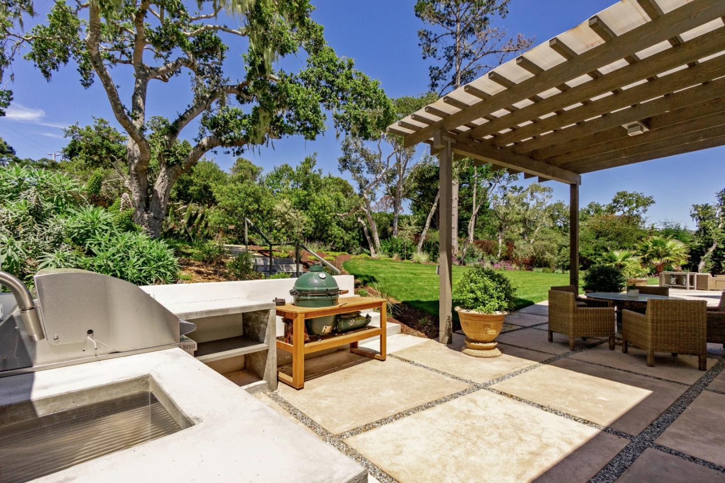 1505 Venadero Road Pebble Beach, CA 93953 - Photo 33 of 36 a view of a patio with table and chairs potted plants with wooden floor and seating space