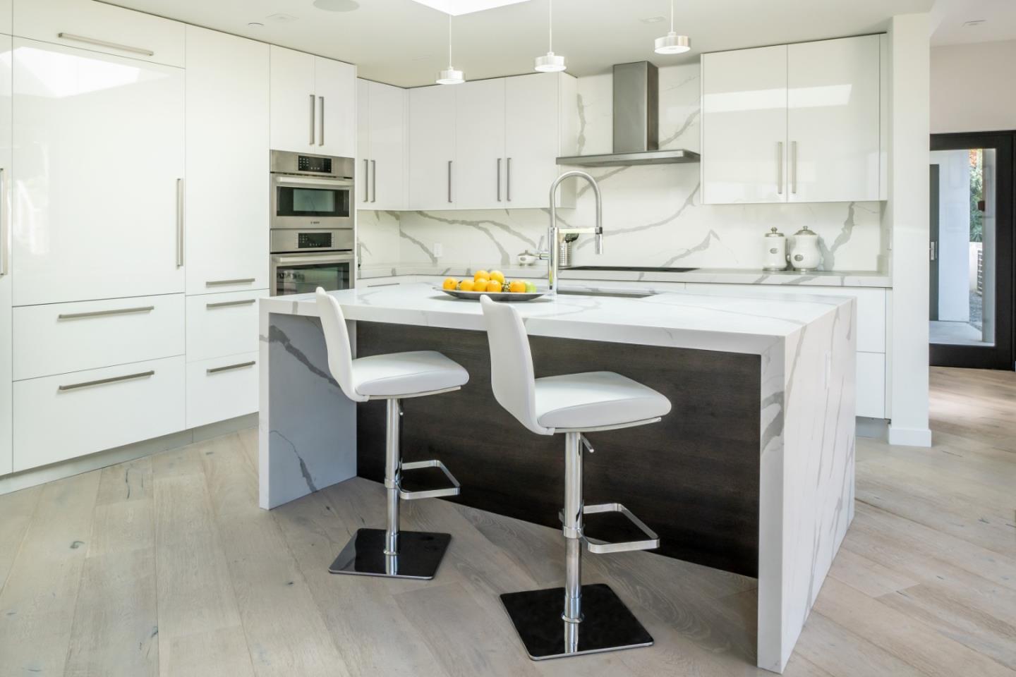 1505 Venadero Road Pebble Beach, CA 93953 - Photo 7 of 36 a kitchen with granite countertop a counter space chairs stainless steel appliances and cabinets