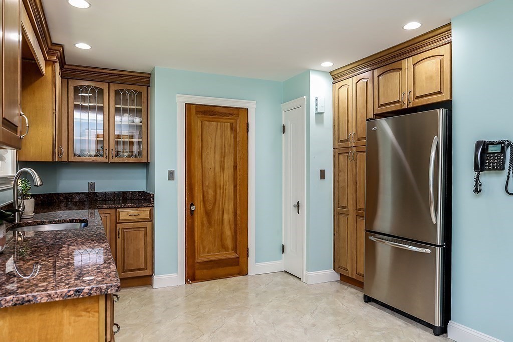 26 Windsor Road Westwood, MA 02090 - Photo 11 of 41 a kitchen with stainless steel appliances granite countertop a refrigerator and a stove top oven