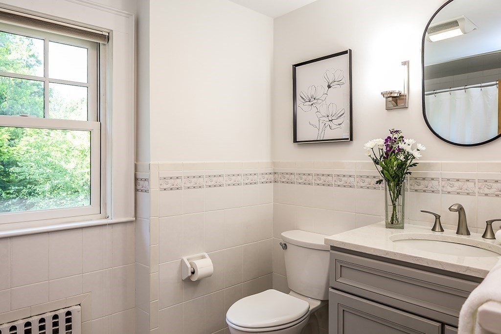 26 Windsor Road Westwood, MA 02090 - Photo 26 of 41 a bathroom with a toilet a sink and a mirror