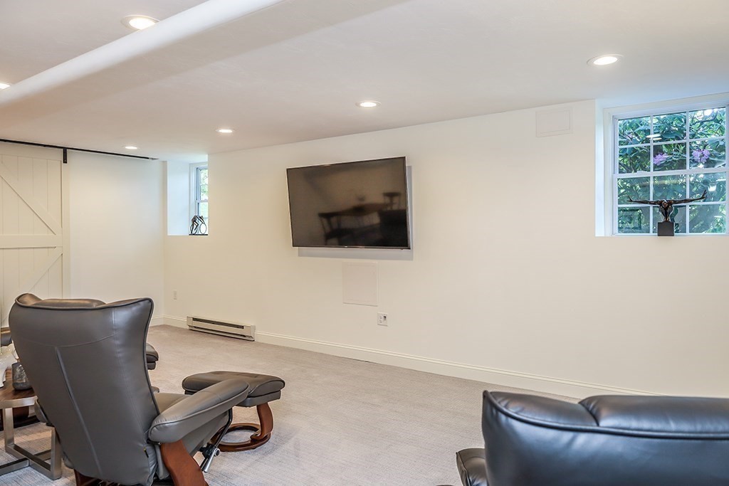 26 Windsor Road Westwood, MA 02090 - Photo 30 of 41 a living room with furniture and a flat screen tv