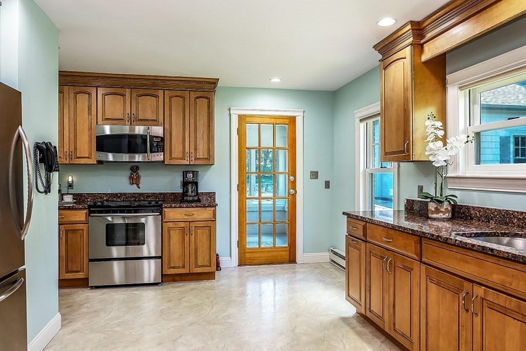26 Windsor Road Westwood, MA 02090 - Photo 10 of 41 a kitchen with stainless steel appliances granite countertop a stove a sink and a refrigerator