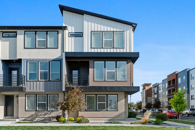 8307 Durham Street Sandy, UT 84070 - Photo 1 of 29 Contemporary multi-level exterior featuring varied siding materials including light brick, horizontal wood-look panels, and vertical ribbed panels