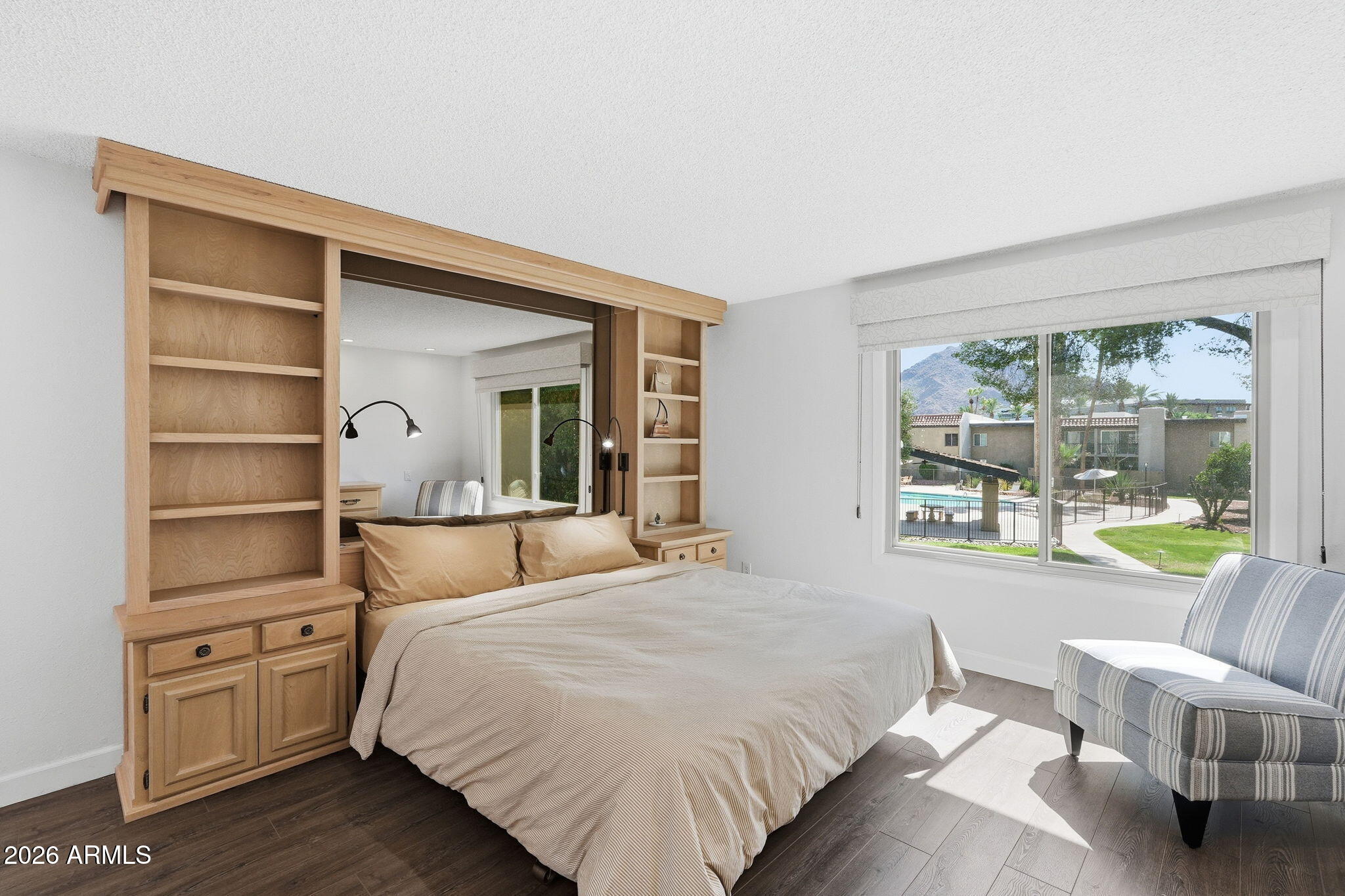 4201 East Camelback Road, Unit 34 Phoenix, AZ 85018 - Photo 10 of 19 a bedroom with a bed and wooden floor