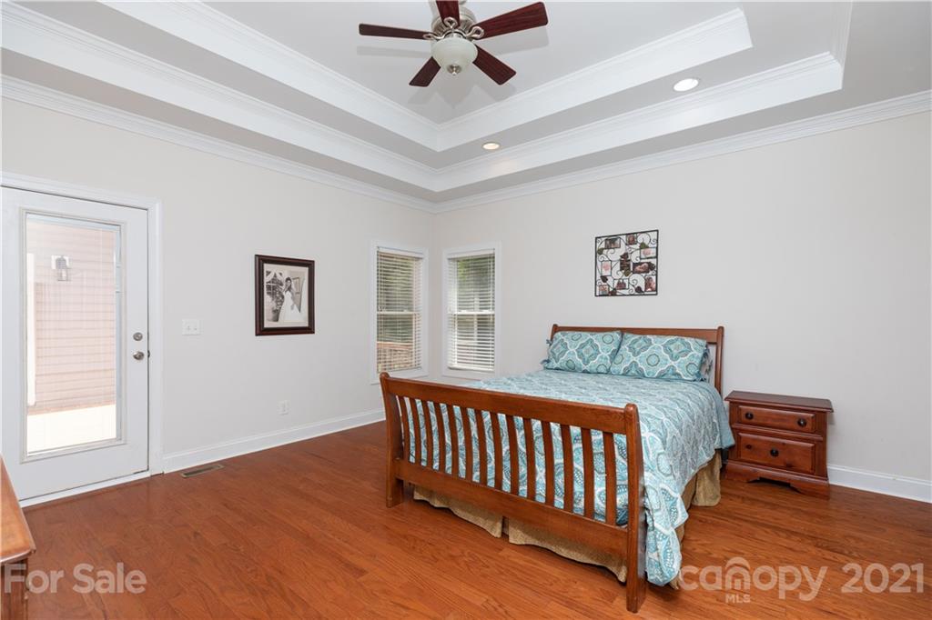 733 Flamingo Road Clover, SC 29710 - Photo 27 of 48 a bedroom with a bed and a chandelier