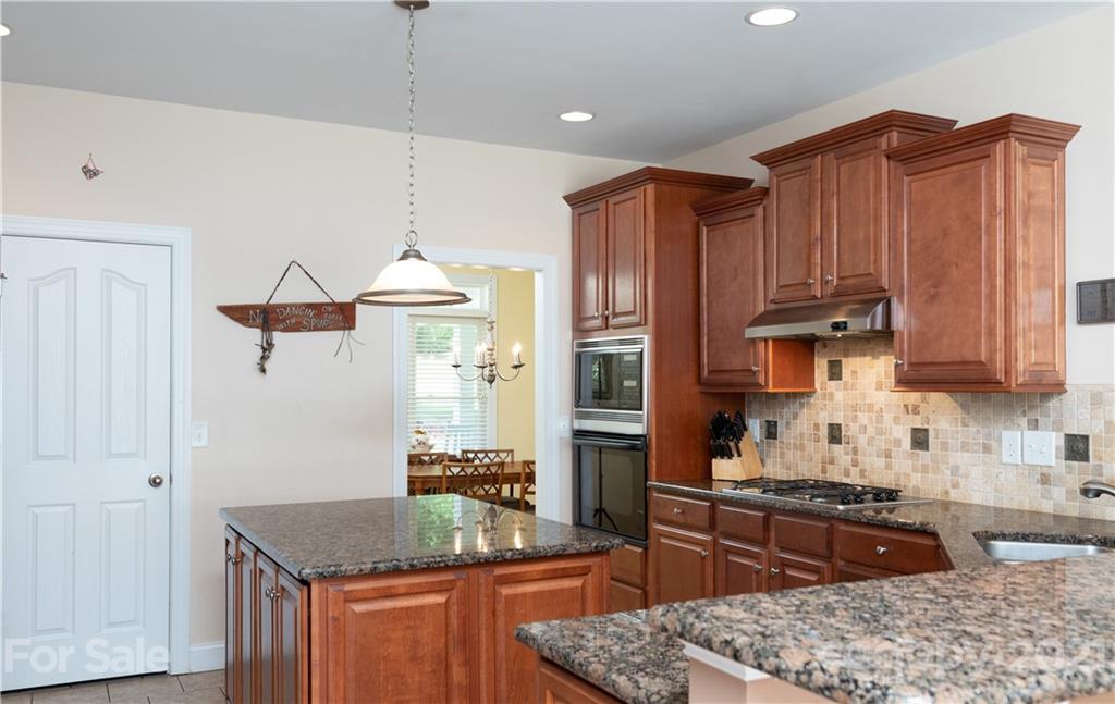 733 Flamingo Road Clover, SC 29710 - Photo 28 of 48 a kitchen with stainless steel appliances granite countertop wooden cabinets a stove a sink and a refrigerator