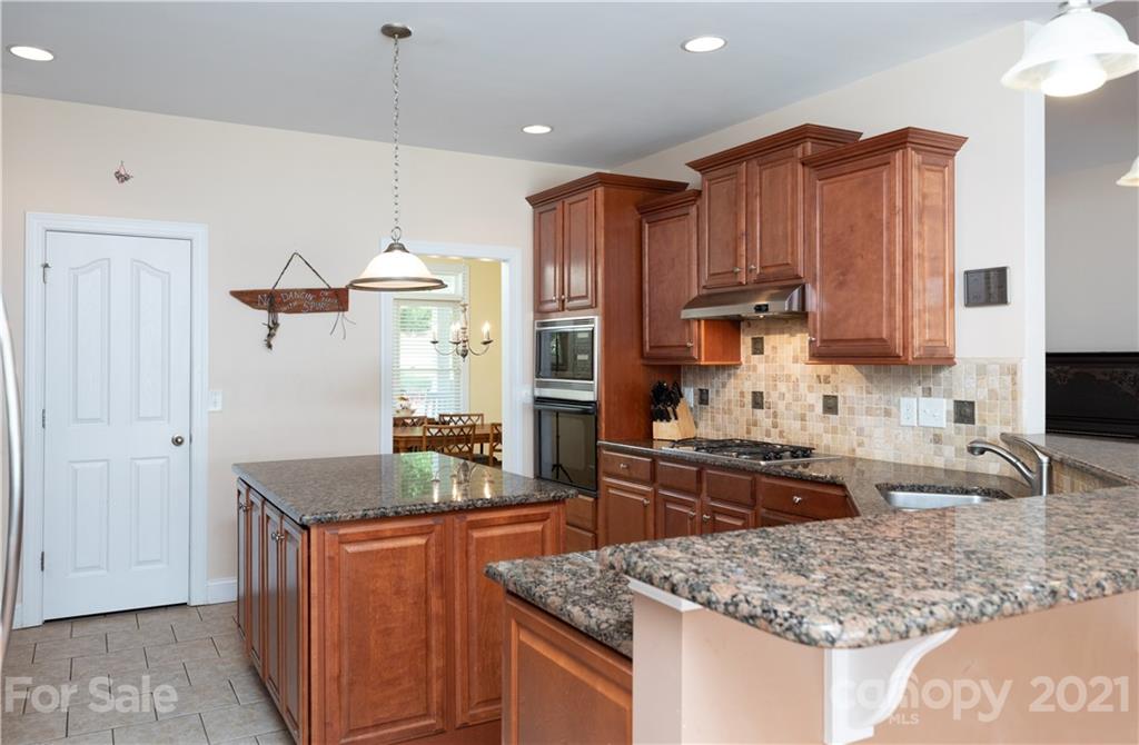 733 Flamingo Road Clover, SC 29710 - Photo 29 of 48 a kitchen with stainless steel appliances granite countertop a stove a sink and a refrigerator