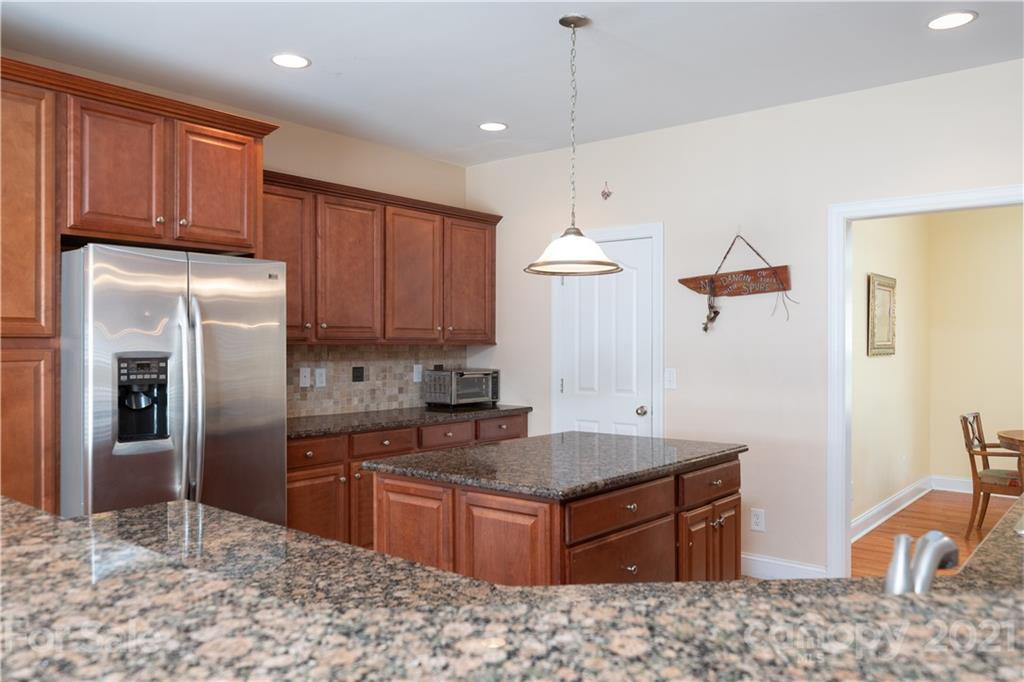 733 Flamingo Road Clover, SC 29710 - Photo 30 of 48 a kitchen with stainless steel appliances granite countertop a refrigerator a sink dishwasher a stove with wooden cabinets and floor