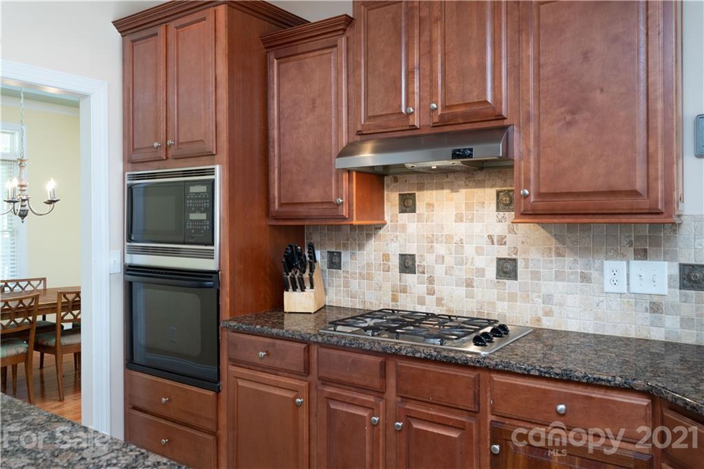 733 Flamingo Road Clover, SC 29710 - Photo 31 of 48 a kitchen with granite countertop a stove and cabinets