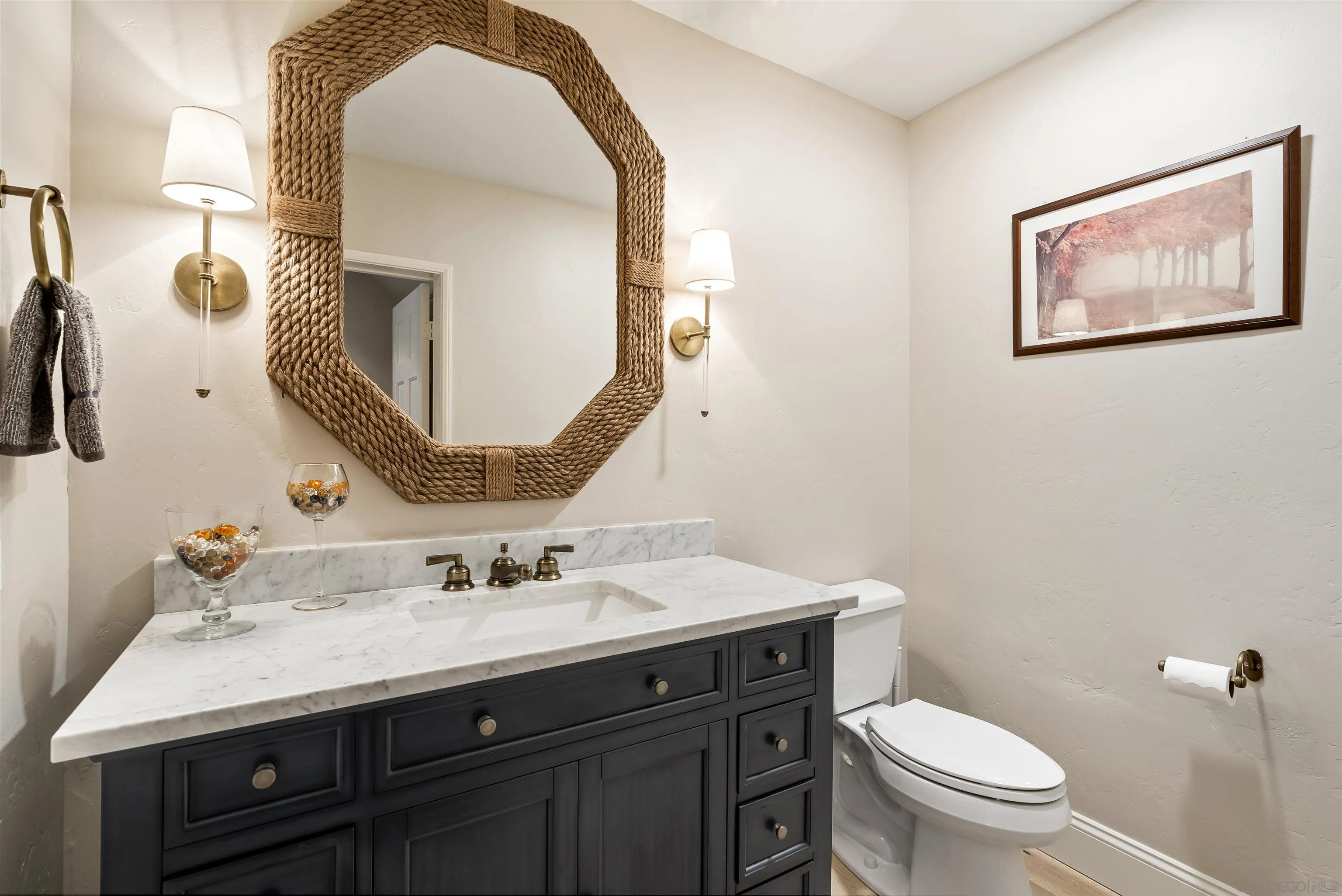 7715 Ivanhoe Avenue La Jolla, CA 92037 - Photo 14 of 28 a bathroom with a toilet sink and mirror