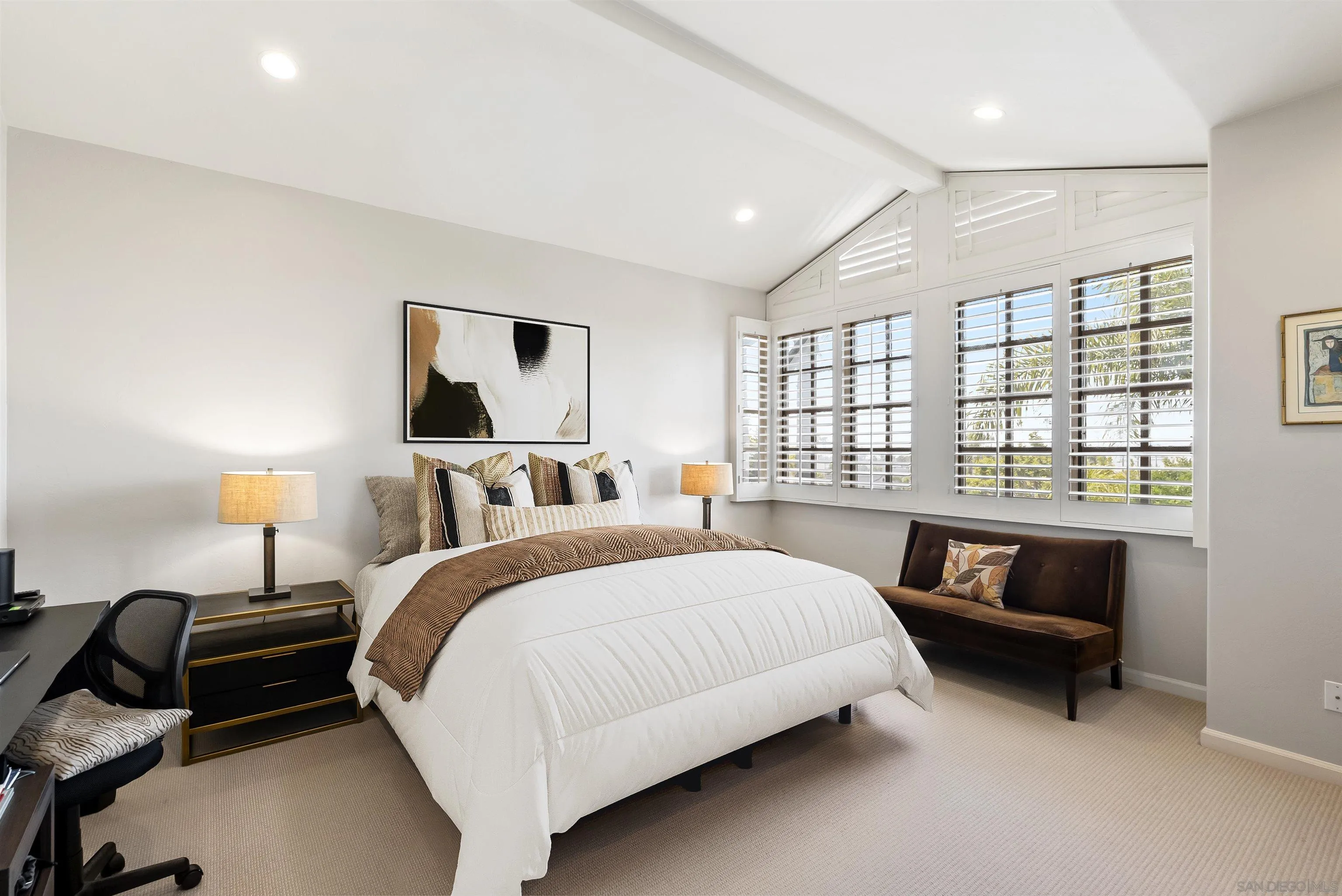 7715 Ivanhoe Avenue La Jolla, CA 92037 - Photo 17 of 28 a spacious bedroom with a bed and a couch