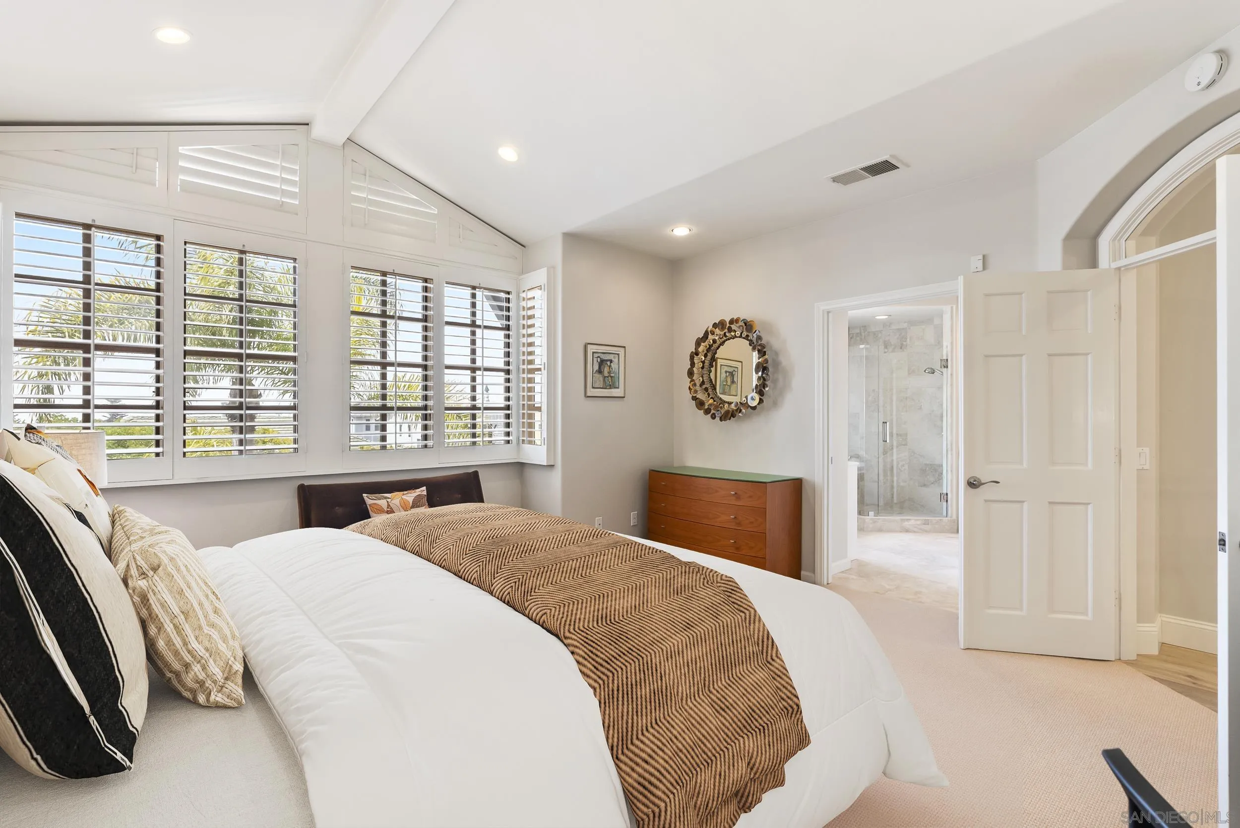 7715 Ivanhoe Avenue La Jolla, CA 92037 - Photo 19 of 28 a bedroom with a large bed and a large window