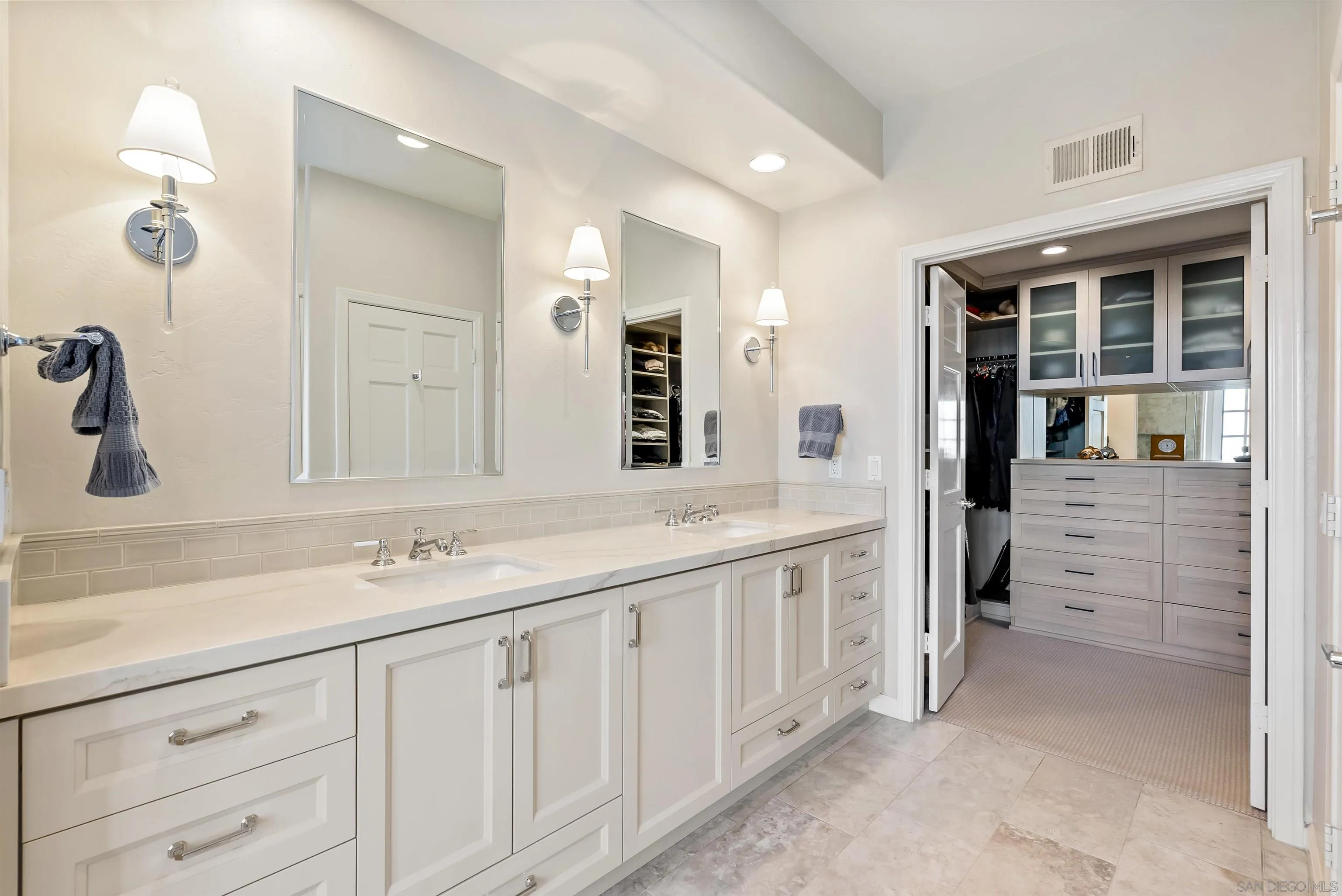 7715 Ivanhoe Avenue La Jolla, CA 92037 - Photo 22 of 28 a bathroom with a double vanity sink and a mirror