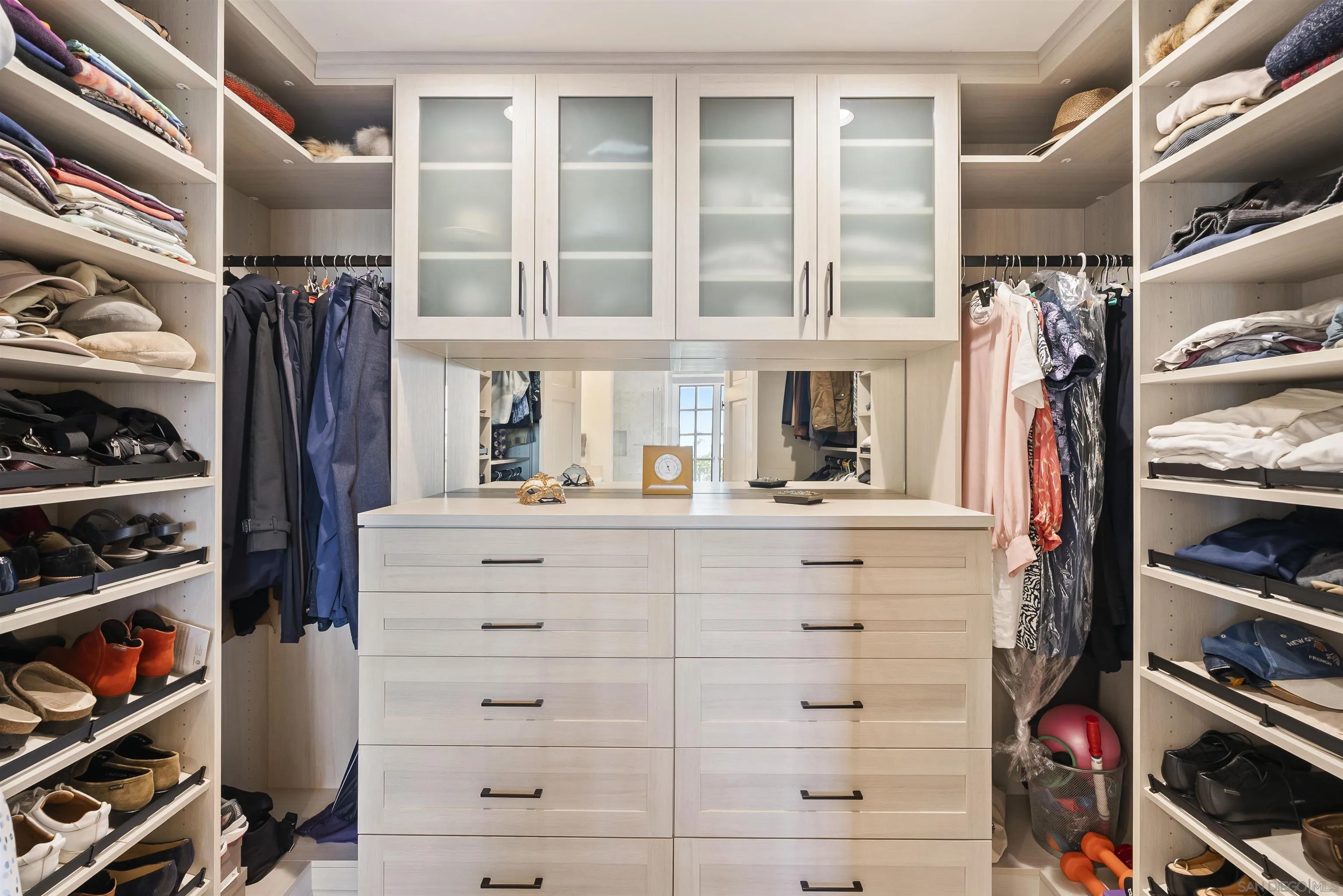 7715 Ivanhoe Avenue La Jolla, CA 92037 - Photo 23 of 28 a view of walk in closet with clothes and shoes