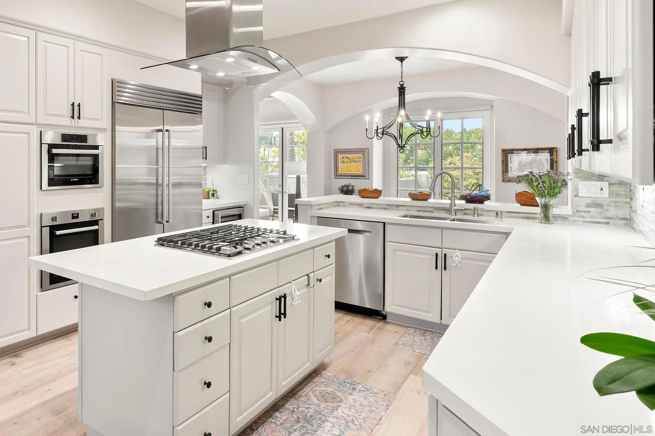 7715 Ivanhoe Avenue La Jolla, CA 92037 - Photo 7 of 28 a kitchen with a sink stove and cabinets