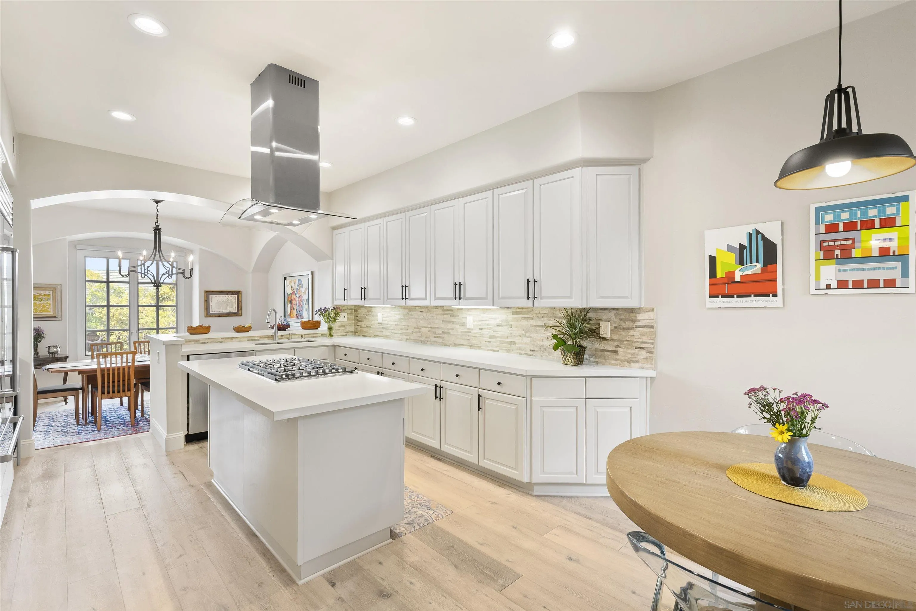 7715 Ivanhoe Avenue La Jolla, CA 92037 - Photo 8 of 28 a kitchen with stainless steel appliances granite countertop a sink a stove and a wooden floors