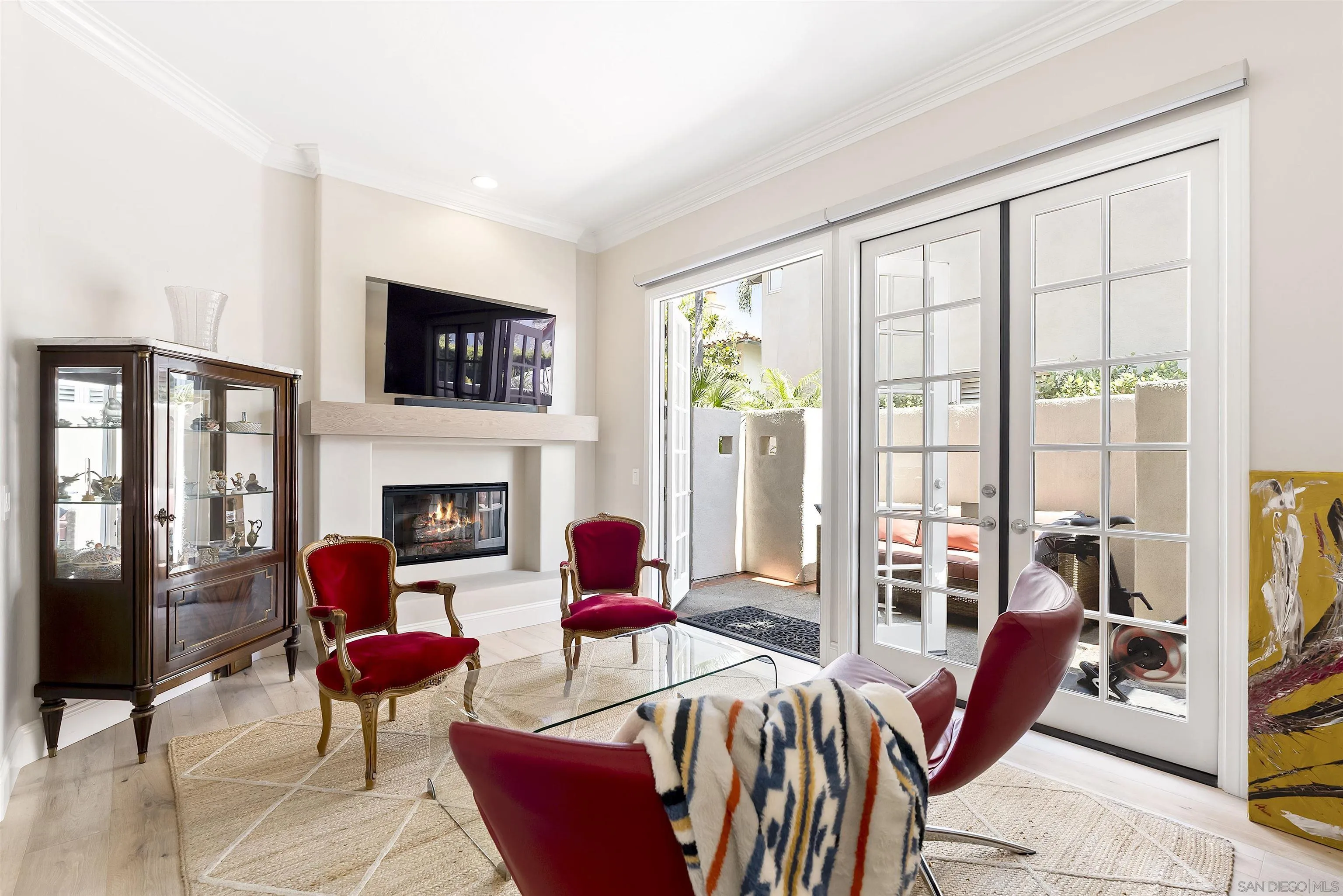 7715 Ivanhoe Avenue La Jolla, CA 92037 - Photo 10 of 28 a living room with furniture fireplace and flat screen tv