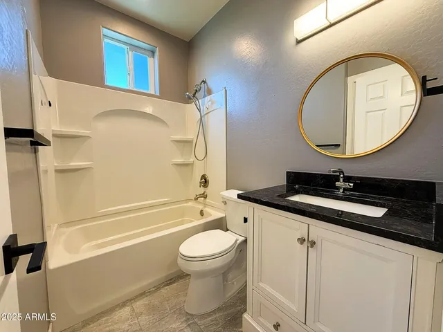 a bathroom with a sink a toilet and a mirror
