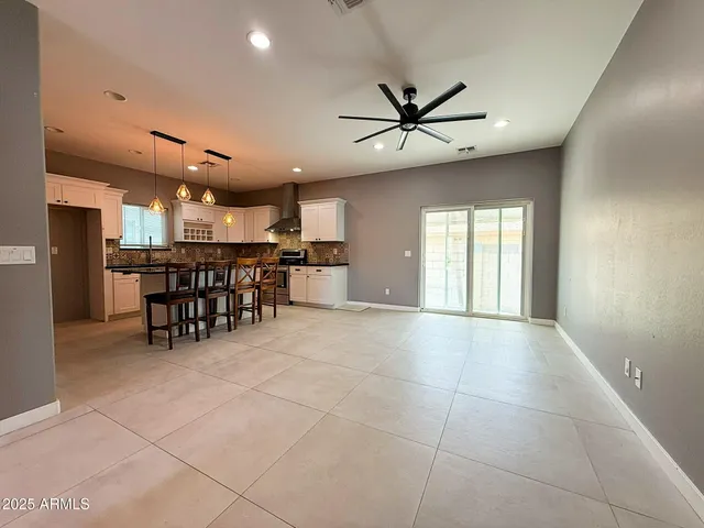 a view of a livingroom with furniture and a ceiling fan