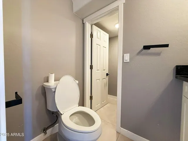 a white toilet sitting next to a bathroom sink