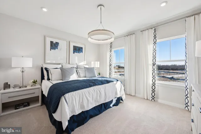 a spacious bedroom with a bed and a refrigerator