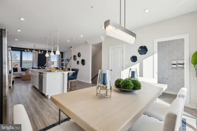 a living room with kitchen island furniture and a chandelier
