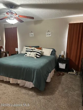 a bedroom with a bed and a mirror