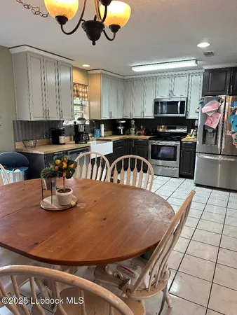 a kitchen with stainless steel appliances wooden cabinets a stove a sink and a refrigerator