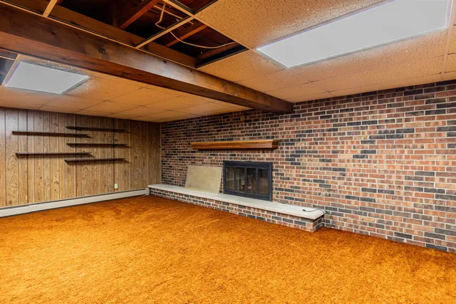 a view of an empty room with a fireplace