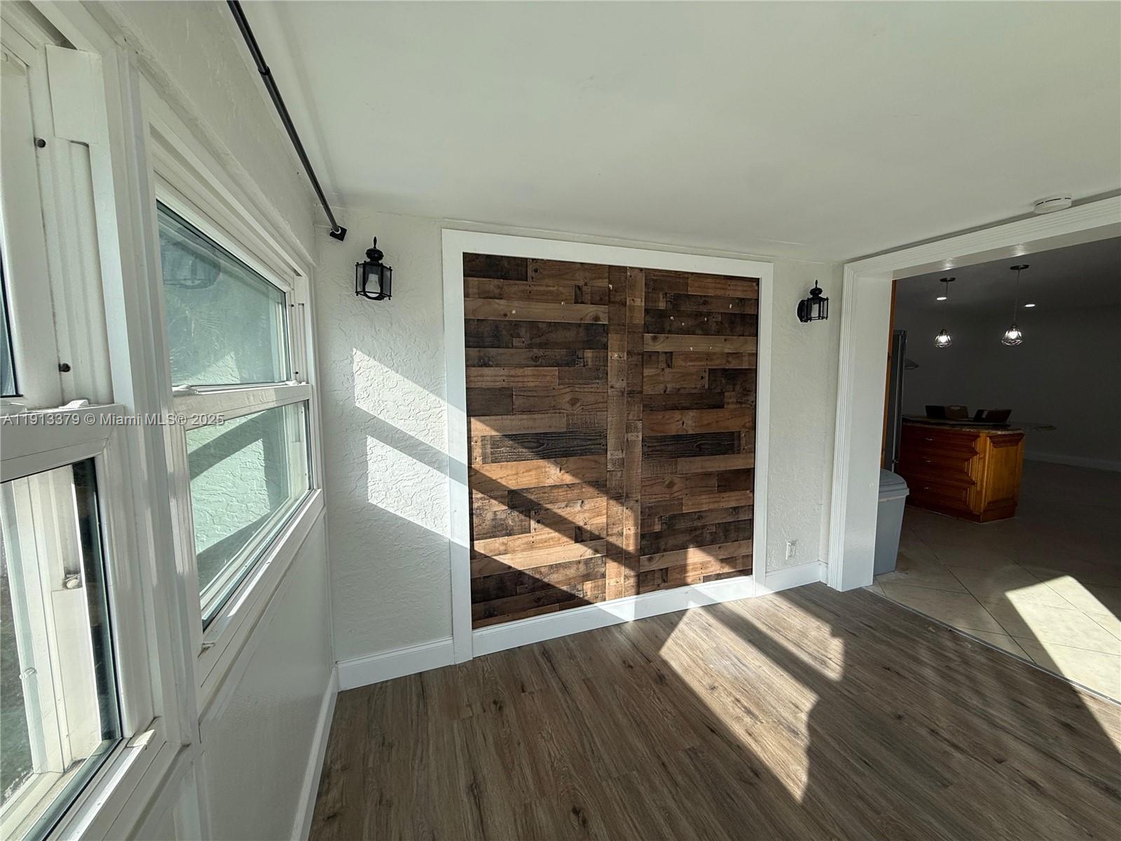 601 Southwest 10th Street Delray Beach, FL 33444 - Photo 7 of 17 a view of a bedroom with wooden floor and windows