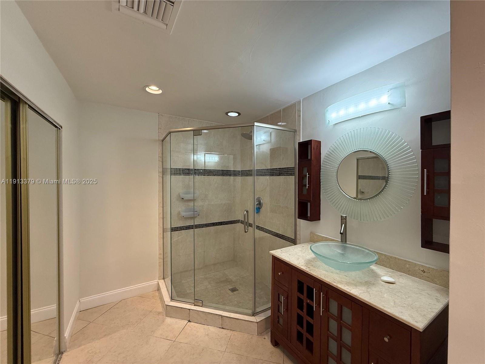 601 Southwest 10th Street Delray Beach, FL 33444 - Photo 8 of 17 a bathroom with a double vanity sink mirror and shower