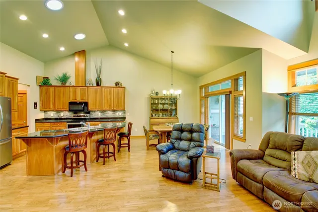 a view of a dining room with furniture wooden floor and chandelier