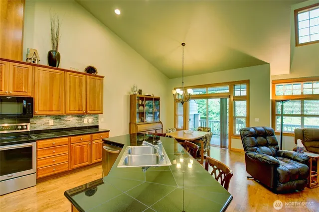 a living room with furniture a fireplace and a chandelier