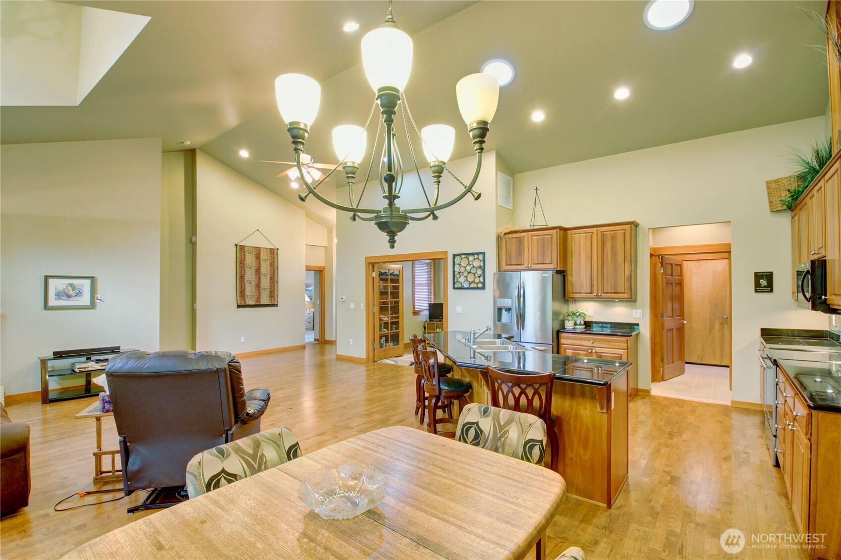 1316 Eagle Ridge Drive, Unit 4 Mount Vernon, WA 98274 - Photo 29 of 29 a living room with couches a dining table and kitchen view with wooden floor