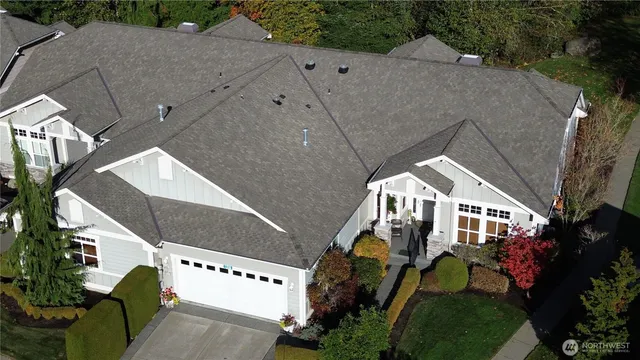 a aerial view of a house with yard swimming pool and outdoor seating