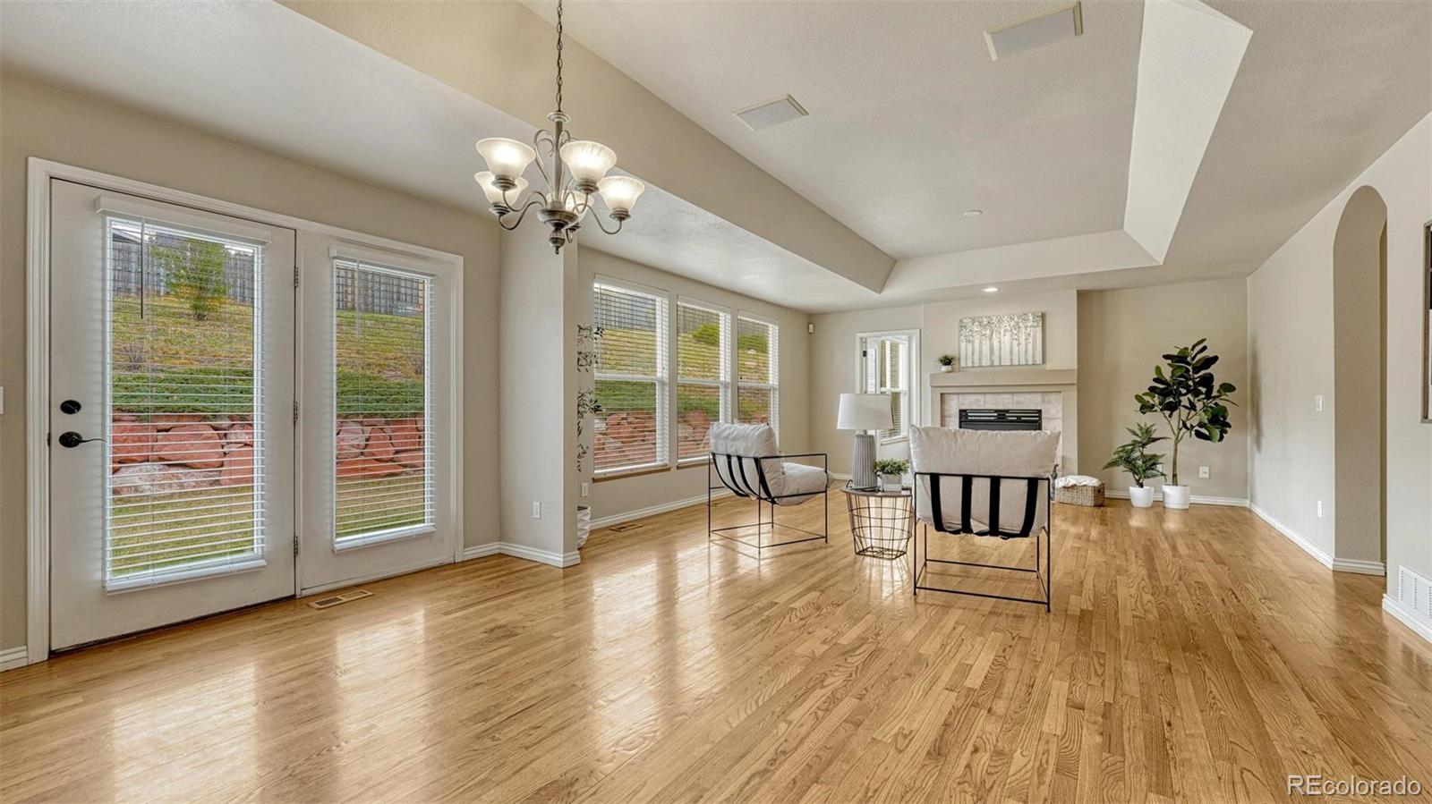 15211 Ridgefield Lane Colorado Springs, CO 80921 - Photo 12 of 47 a view of a livingroom with furniture wooden floor and windows