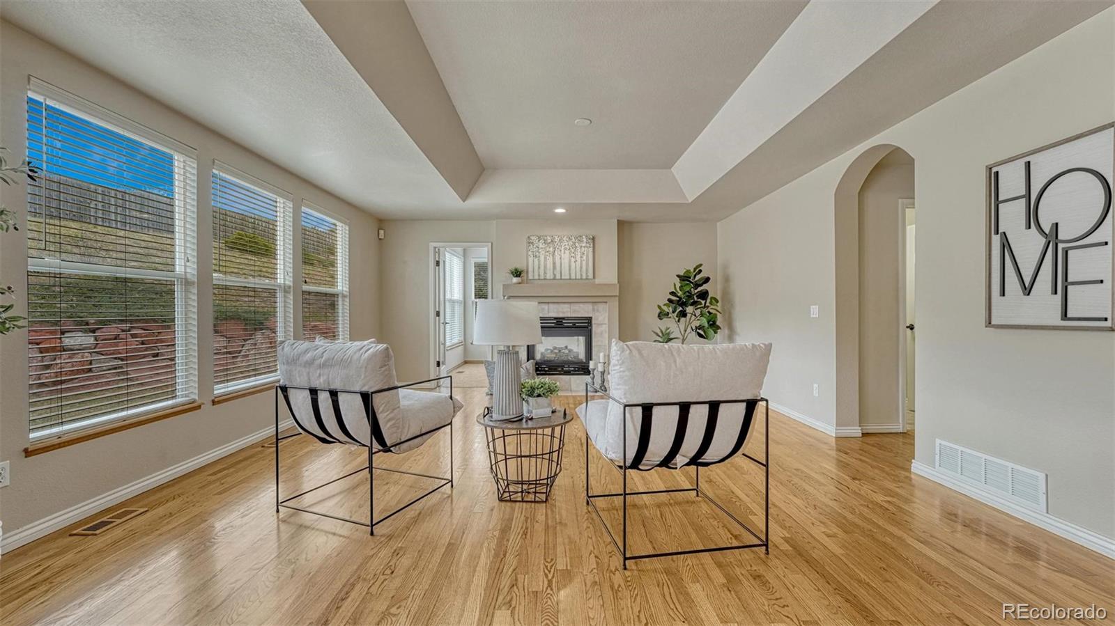 15211 Ridgefield Lane Colorado Springs, CO 80921 - Photo 13 of 47 a view of a dining room with furniture window and wooden floor