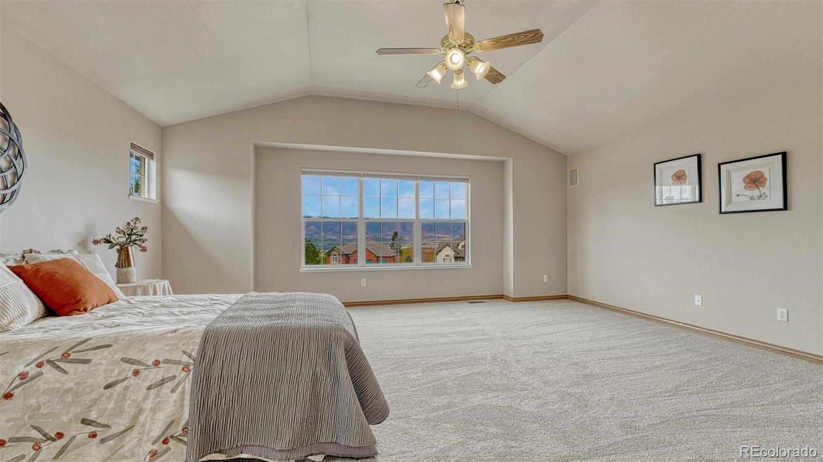 15211 Ridgefield Lane Colorado Springs, CO 80921 - Photo 21 of 47 a large bedroom with a bed and a window