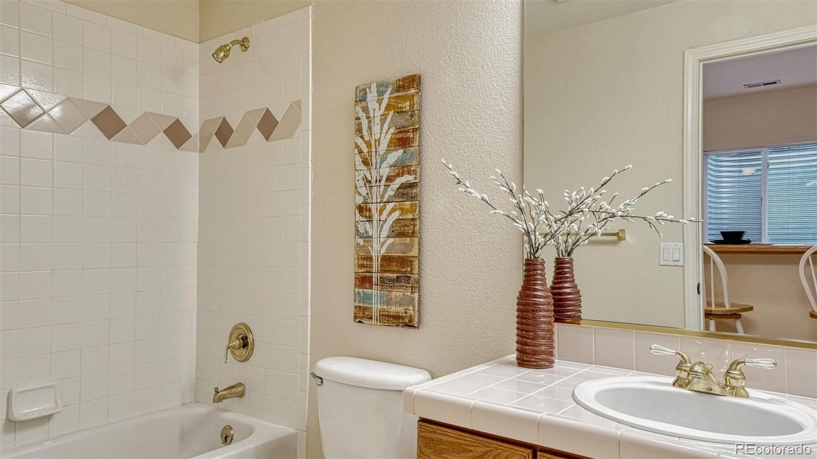 15211 Ridgefield Lane Colorado Springs, CO 80921 - Photo 35 of 47 a bathroom with a sink a toilet and a mirror