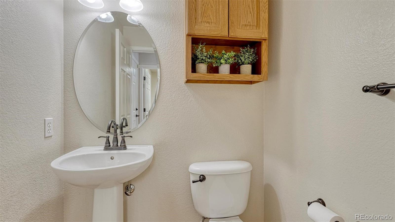 15211 Ridgefield Lane Colorado Springs, CO 80921 - Photo 38 of 47 a bathroom with a toilet a sink and mirror