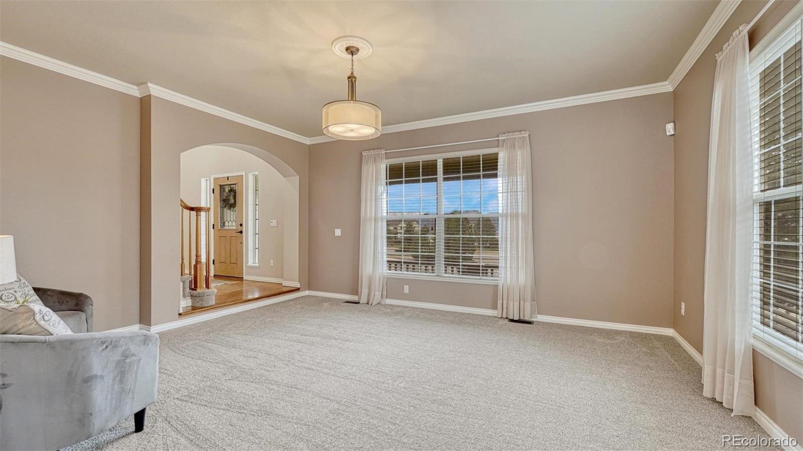 15211 Ridgefield Lane Colorado Springs, CO 80921 - Photo 7 of 47 a view of an empty room with a window and kitchen view
