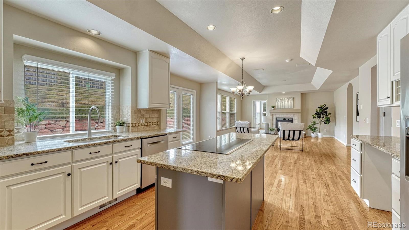 15211 Ridgefield Lane Colorado Springs, CO 80921 - Photo 10 of 47 a large kitchen with granite countertop a large window