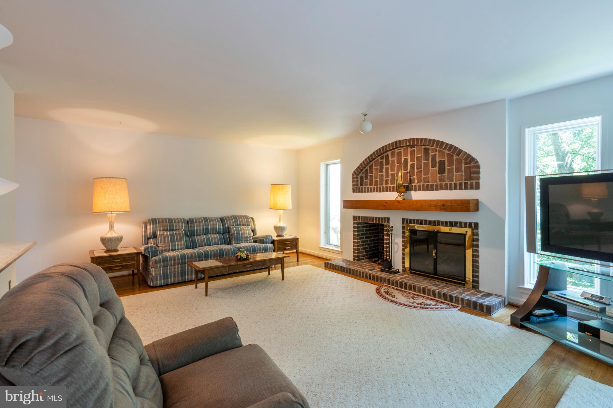 309 Valley Place Radnor, PA 19087 - Photo 19 of 39 a living room with furniture a fireplace and a flat screen tv