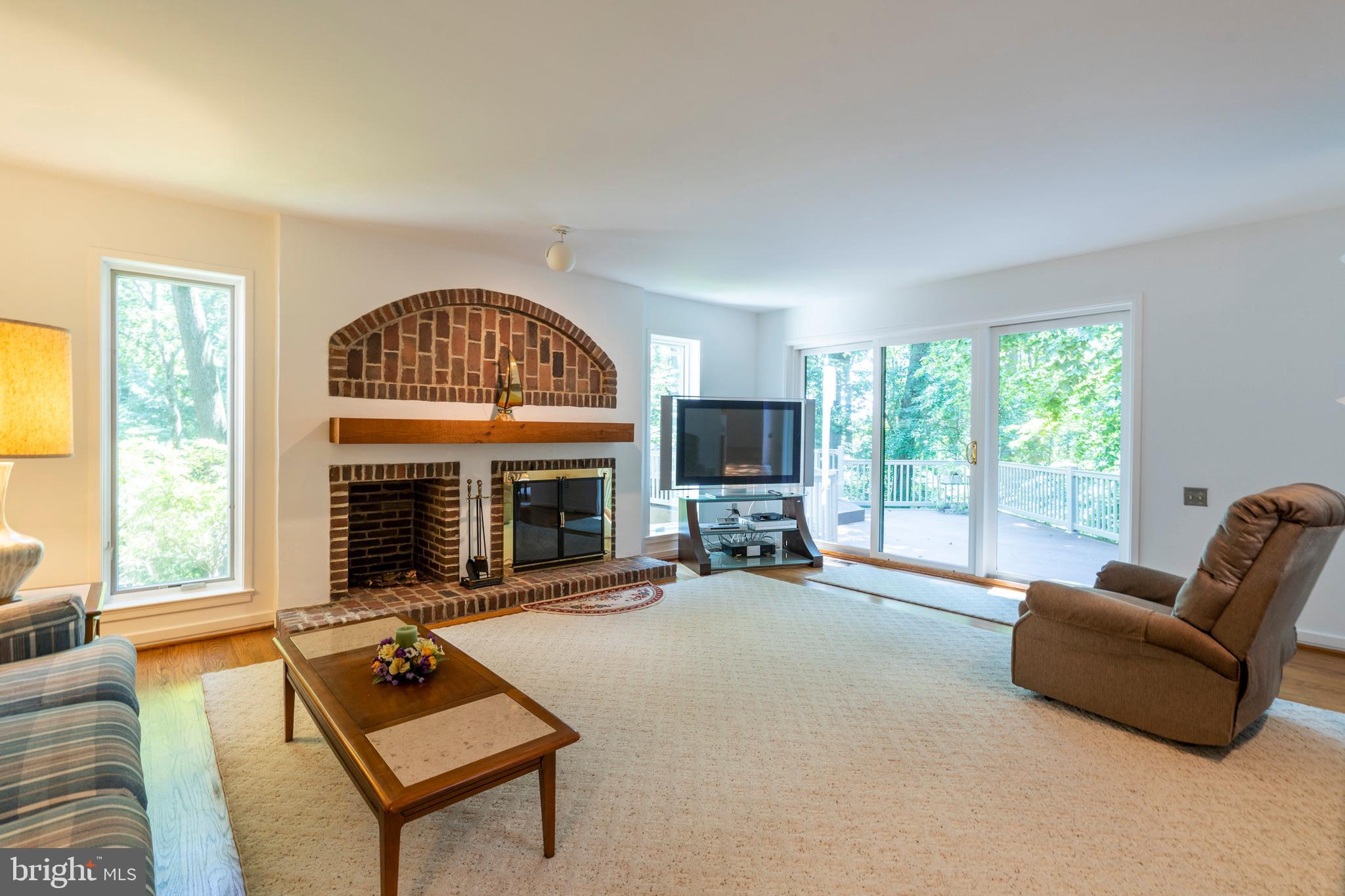 309 Valley Place Radnor, PA 19087 - Photo 20 of 39 a living room with furniture a fireplace a flat screen tv and a large window