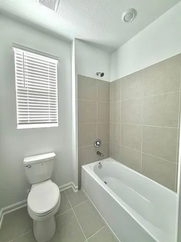 a bathroom with a toilet and a bathtub