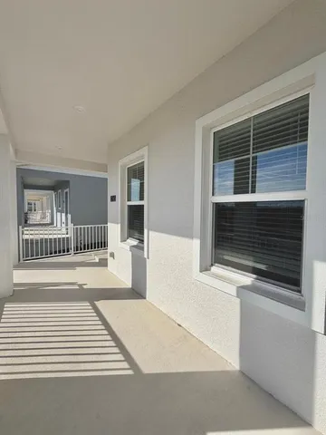 a view of a room with wooden floor and windows