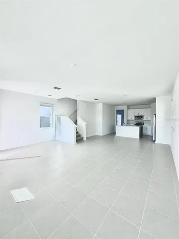 a view of empty room with furniture and a window